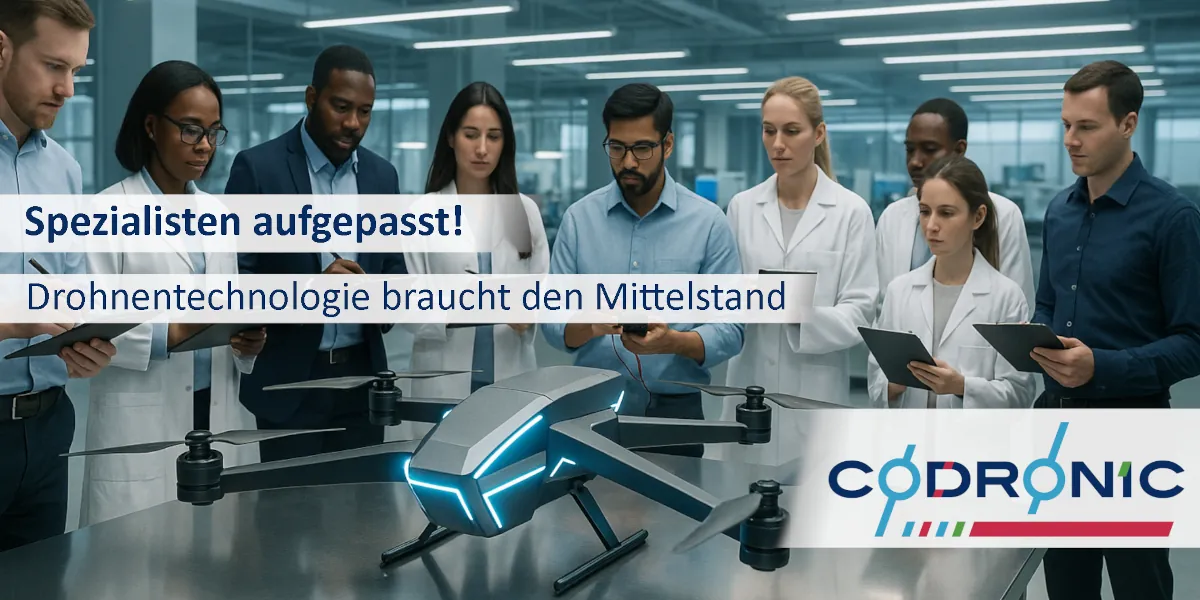 Ein Bild in einer Laborumgebung mit einer Drohne auf dem Tisch. Viele Forscher stehen rundherum.